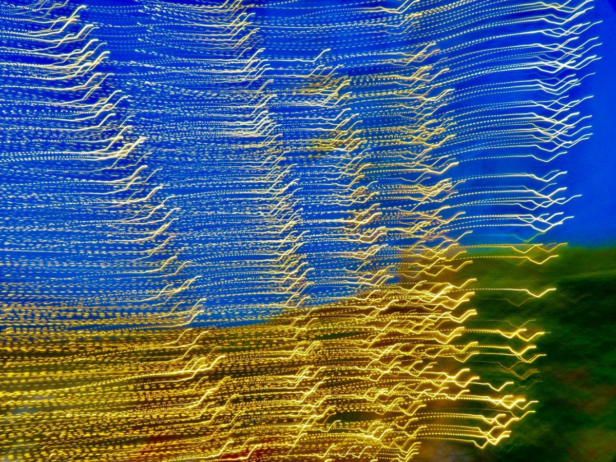 Abstract artwork featuring dynamic yellow light trails against a blue background, creating a vibrant contrast.