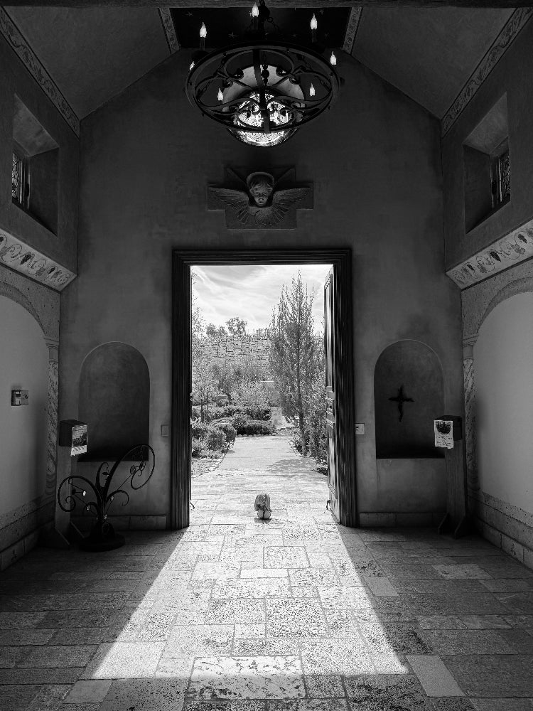 Church with open door leading to a garden