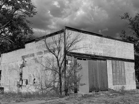 Abandoned building with a large sign on a cloudy day